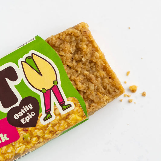 Oat bar with green packaging featuring a cartoon character on a white background