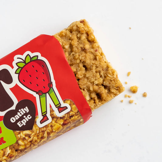 Oat bar with red packaging featuring a strawberry character on a white background