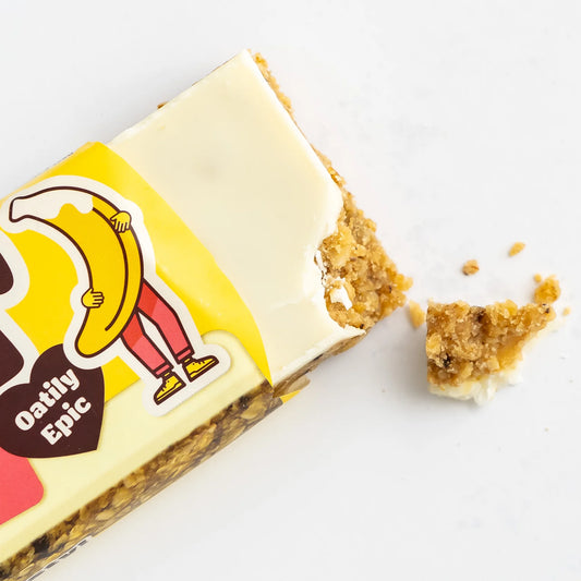 Oat bar with a bite taken out of it on a white background