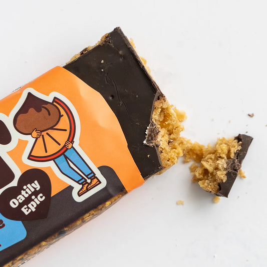 Oatily Epic snack bar with a bite taken out of it on a white background