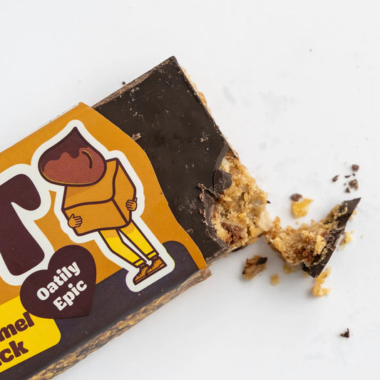 Oatily Epic snack bar with a bite taken out of it on a white background