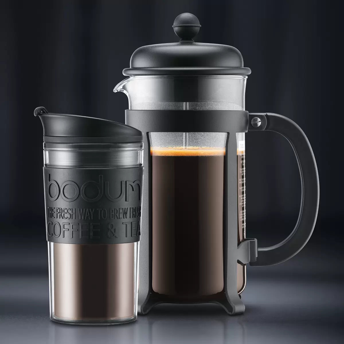 Bodum French press and travel mug on a dark background