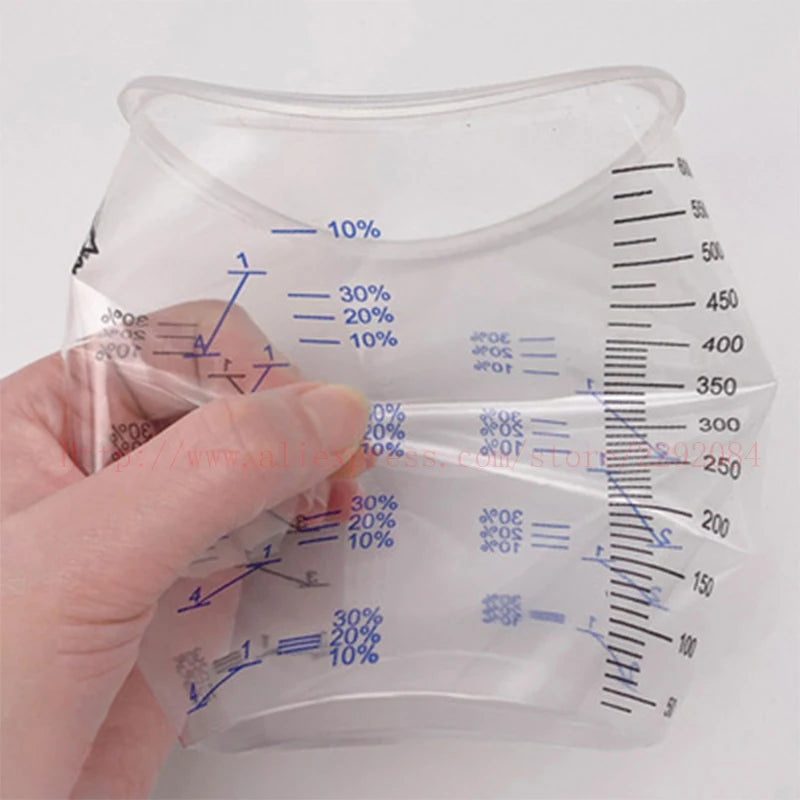 Clear plastic measuring bag with measurement markings held by a hand against a white background