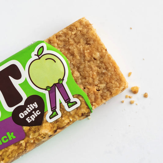 Oat bar with green label featuring a cartoon apple character on a white background