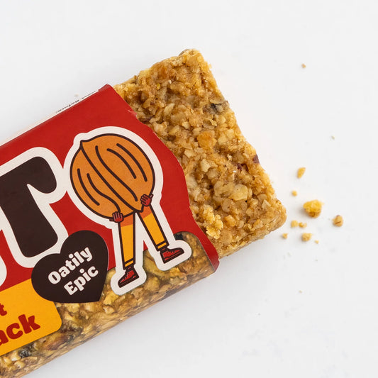 Granola bar with a red and yellow packaging featuring a cartoon character on a white background